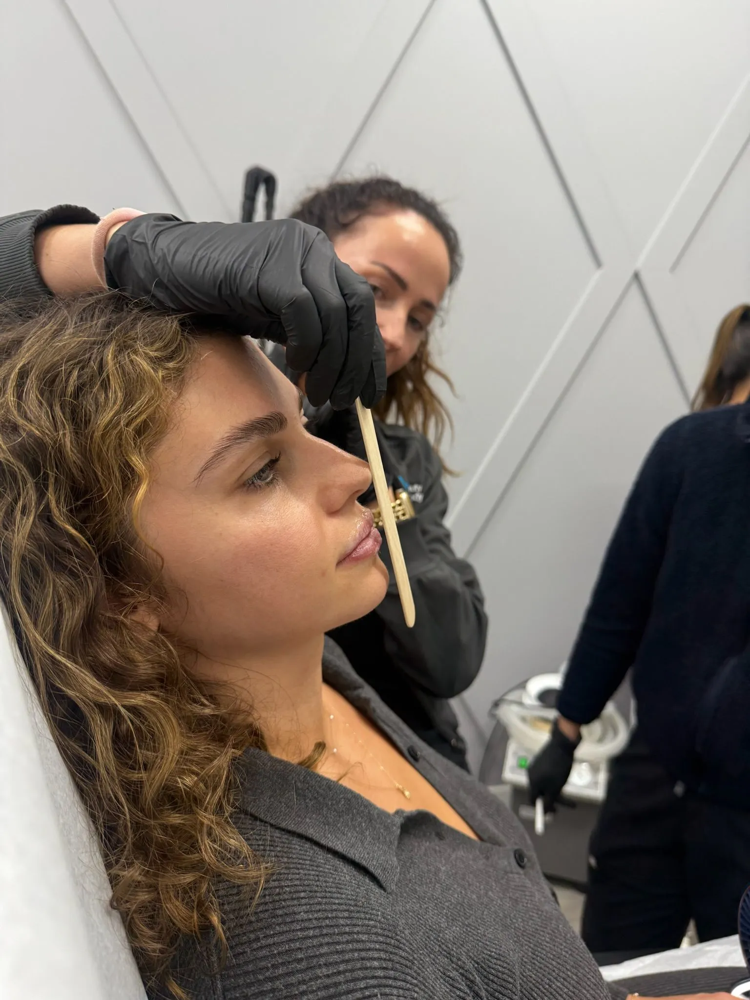 Practitioner marking a patient's face during a thoughtful aesthetic consultation